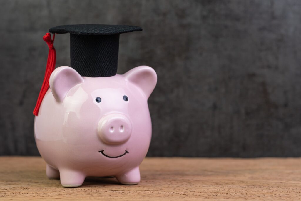 Piggy bank with a graduate hat on.