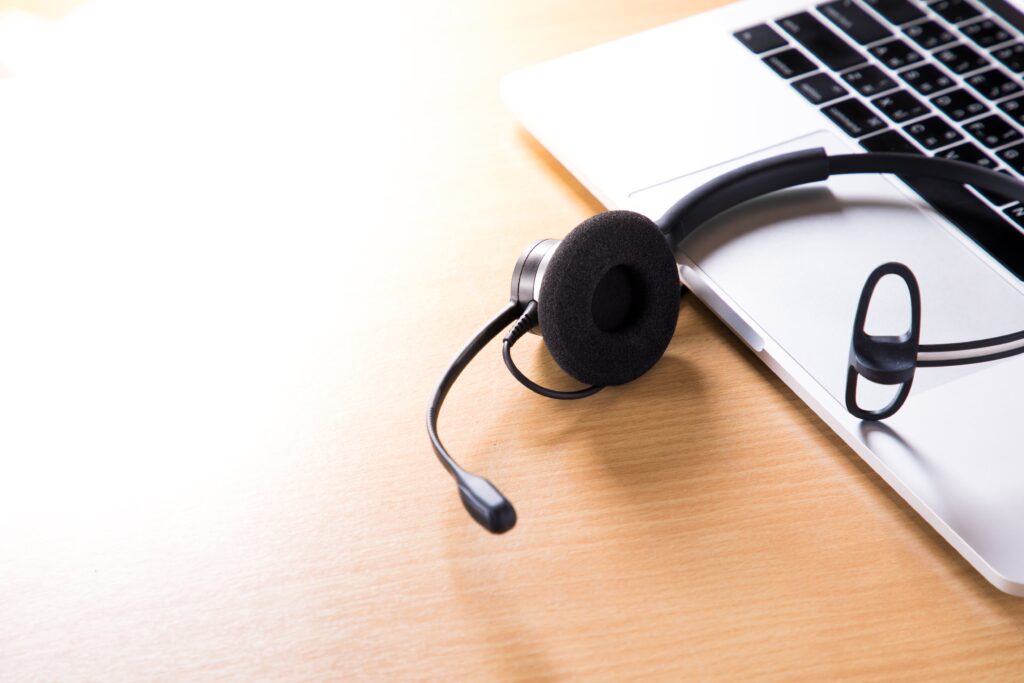 Headset resting on a laptop.