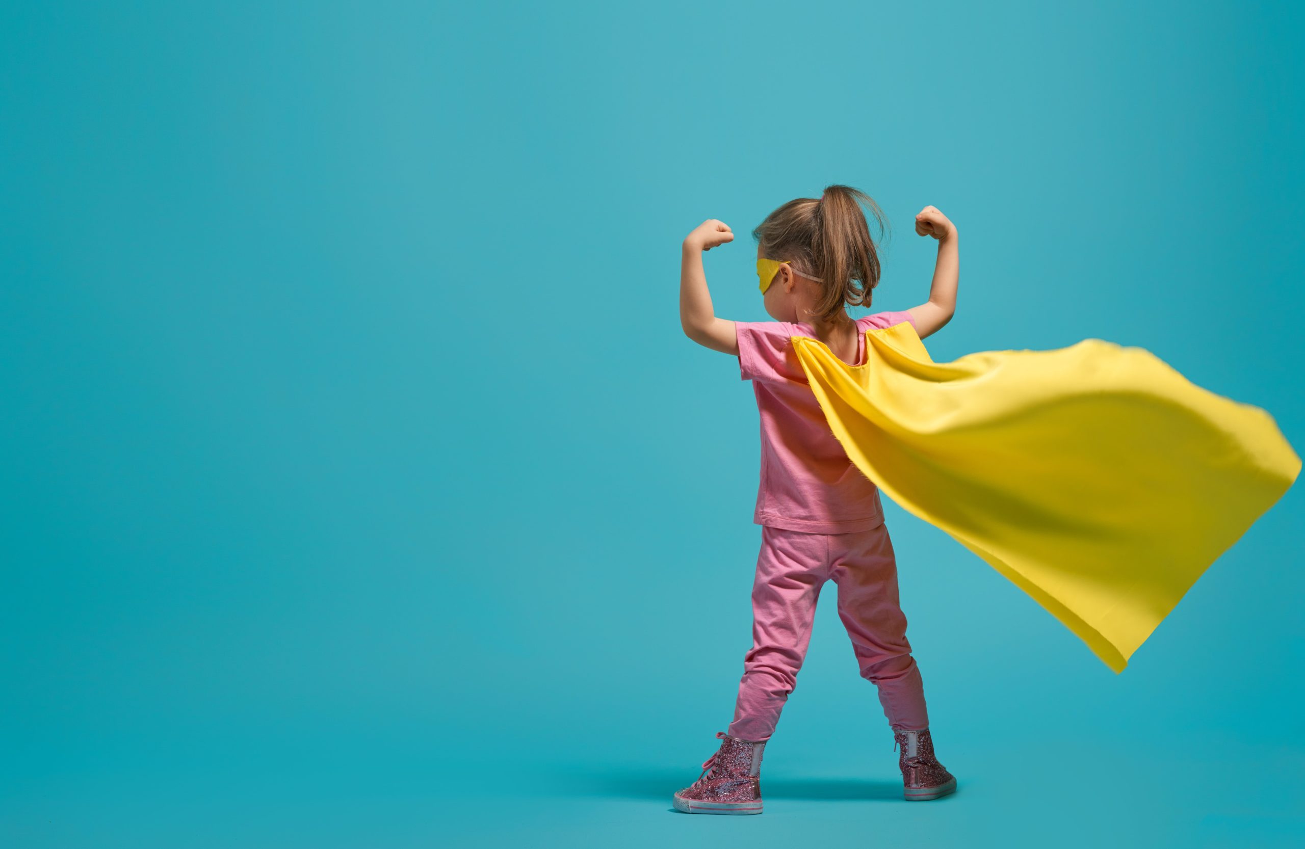 Girl dressed as a superhero.