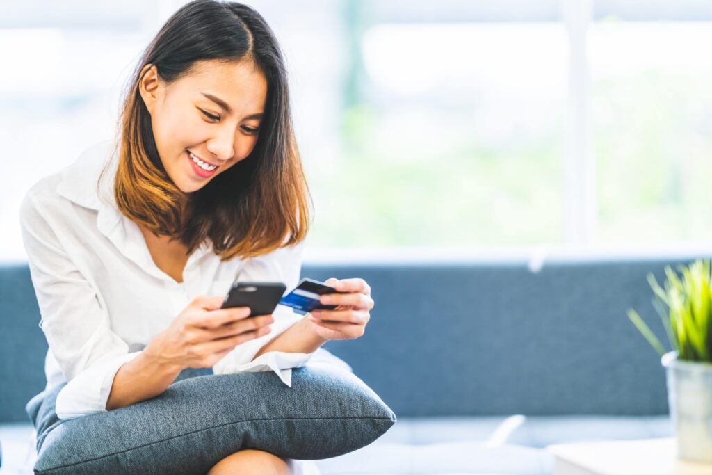 Woman making a credit card payment over the phone.